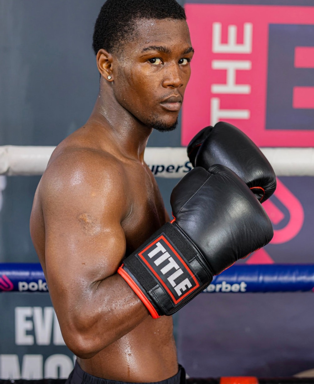 Sanele Sogcwayi in guard wearing Title boxing gloves in the ring